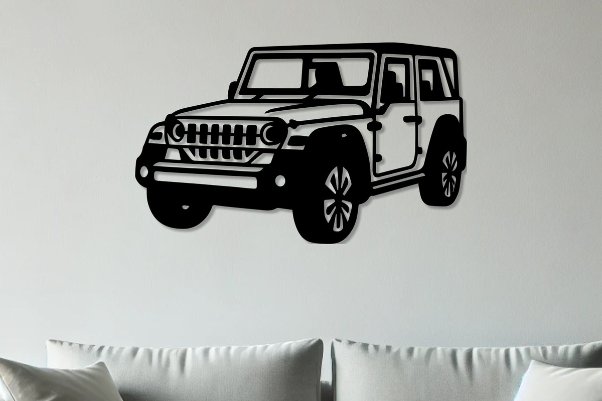 Mahindra Thar wall art: Thar Roxx black metal silhouette above a grey sofa on a light grey wall