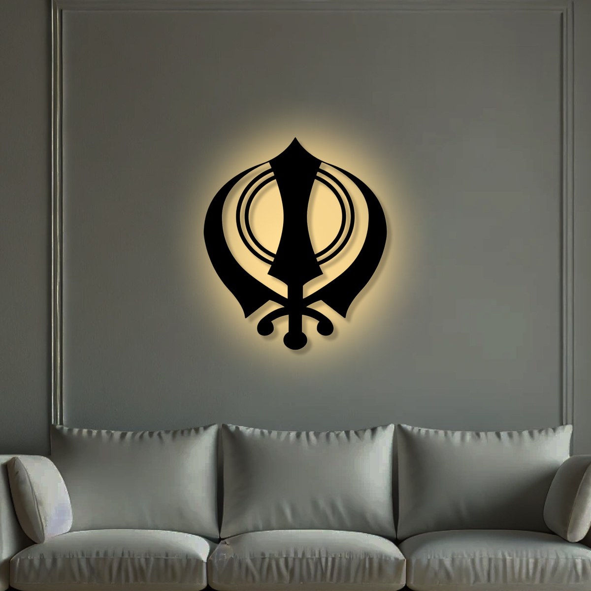 Sikh wall art: black laser-cut Khanda metal wall art glowing above a grey sofa