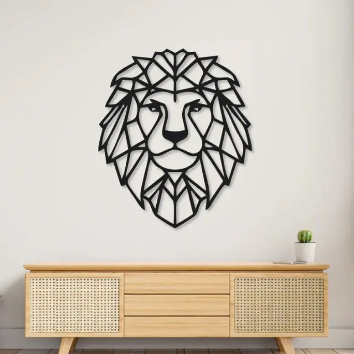 Lion wall art: black laser-cut geometric lion metal wall art above a rattan sideboard