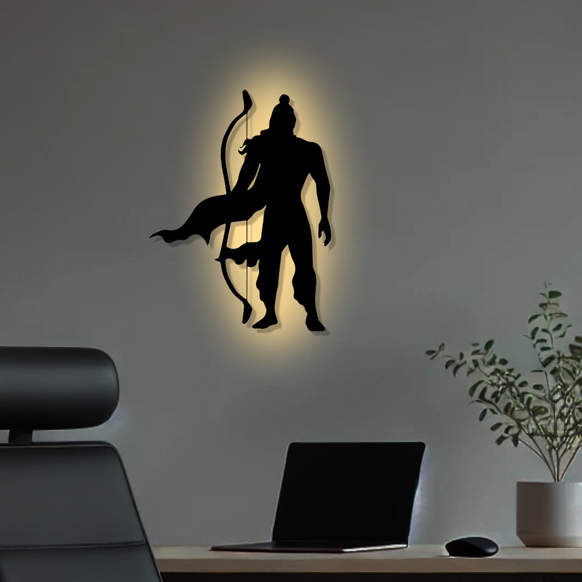 Shri Ram wall art: black laser-cut metal Lord Ram silhouette with a warm backlight glow above a home office desk