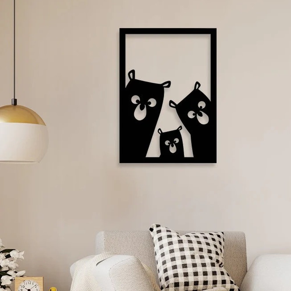 Bear wall art: black laser-cut metal bear family design in a rectangular frame on a beige wall above a sofa