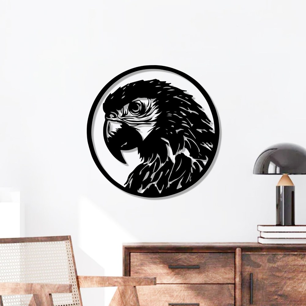 Tropical bird wall art: black laser-cut parrot metal wall art in a circle above a wooden sideboard and lamp