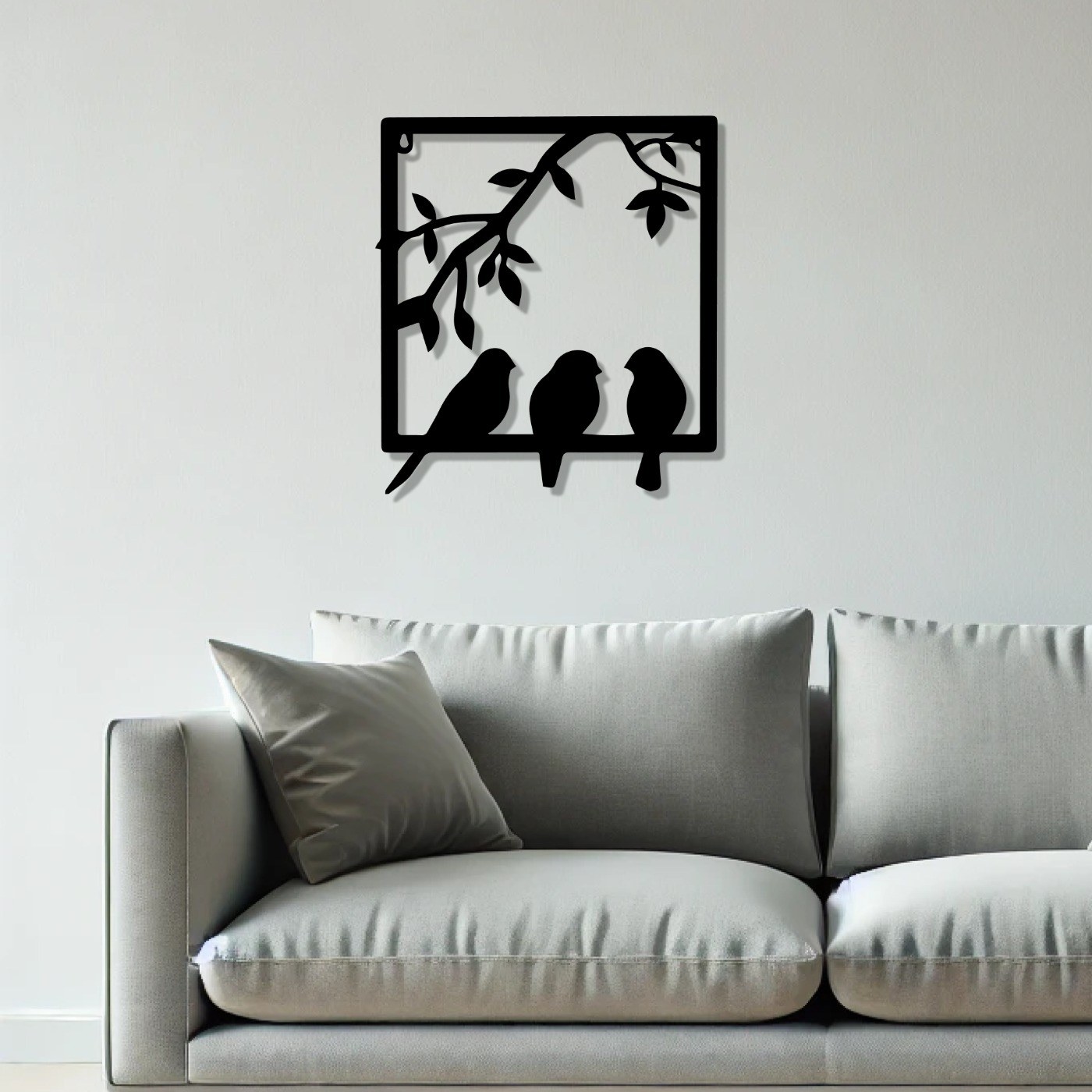 Birds on branch wall art: Birds in Frame laser-cut metal design with three birds above a grey sofa