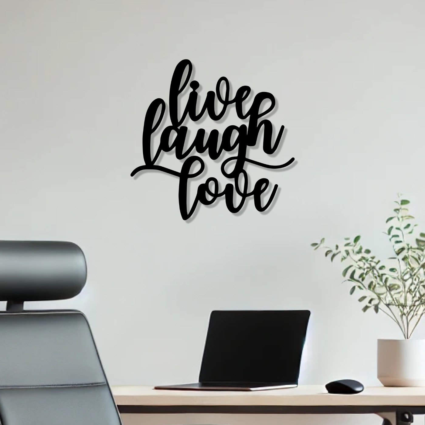 Live Laugh Love quote wall art in black metal above a home office desk
