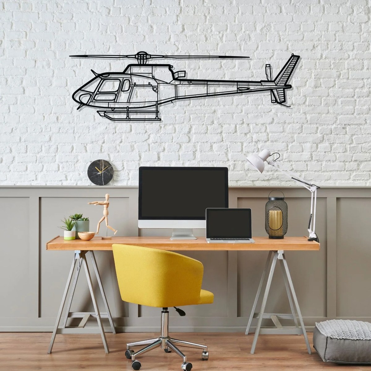 H145 helicopter wall art above a desk in a bright home office