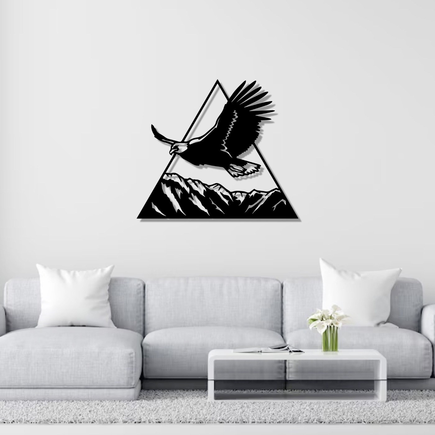 Eagle on mountain wall art above a grey sofa in a bright living room